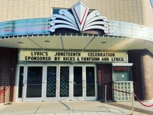 Photo of exterior of Lyric Theatre & Cultural Arts Center’s sign displaying Juneteenth event and Hicks & Funfsinn sponsorship. 